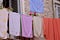 Multi-colored laundry dries after washing outside the window on the street/ Typical Mediterranean scene