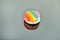 Multi colored macaron on a gray background with reflection