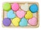 multi colored macaroons on a wooden tray