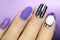 Multi-colored manicure with white and lilac varnish on various forms of nails