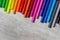 Multi-colored markers for drawing, tools for children's creativity top view on a gray background, copy space, close-up