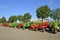 Multi colored old restored tractor lineup