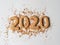 Multi colored pastry sugar topping and gingerbread in the form of numbers 2020 on a white background. 2020 new year ginger cookies