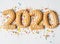 Multi colored pastry sugar topping and gingerbread in the form of numbers 2020 on a white background. 2020 new year ginger cookies