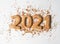 Multi colored pastry sugar topping and gingerbread in the form of numbers 2021 on a white background. 2021 new year ginger cookies