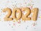 Multi colored pastry sugar topping and gingerbread in the form of numbers 2021 on a white background. 2021 new year ginger cookies