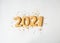 Multi colored pastry sugar topping and gingerbread in the form of numbers 2021 on a white background. 2021 new year ginger cookies