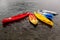 Multi-colored plastic kayaks are on the pier near the shore