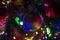 Multi-colored rainbow Christmas ball hanging on a Christmas tree