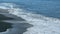 Multi-Colored Round Sea Pebble On Sea Coast. Wave Leaves White Marks. Slow motion.