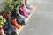 Multi-colored rubber boots as flower pots with different blooming flowers on the veranda