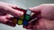 Multi colored rubic cube in hands