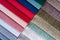 Multi colored set of upholstery fabric samples for selection, collection of textile swatches