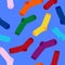 Multi-colored socks on a blue background seamless pattern. View from above
