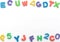 Multi-colored soft English letters and numbers on white background with copy space. Kid`s set for teaching reading and counting.
