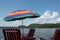 A multi-colored sunshade umbrella on a lakeside dock