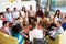 Multi-Cultural Office Staff Sitting Having Meeting Together