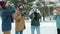 Multi-ethnci group of friends clinking take-out coffee cups drinking laughing talking after ice-skating