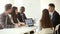 Multi-ethnic business team sharing ideas sitting at conference office table