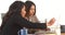 Multi-ethnic businesswomen doing research at desk