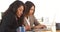 Multi-ethnic businesswomen doing research at desk