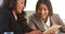 Multi-ethnic businesswomen reviewing information on tablet