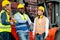 Multi ethnic cargo contianer workers stand and relax with happiness during work in workplace area