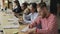 Multi-ethnic concentrated team of coworkers working on technology startup project in openspace office. Young hipster man