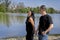 Multi-ethnic couple formed by an Andean woman and a Caucasian man walking by a lake