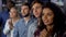 Multi-ethnic girl with friends rooting for national team, event audience