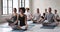 Multi-ethnic girls guys sitting in lotus position do meditation practice