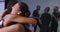 Multi-ethnic group of fit male and female modern dancers embracing each other