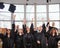 Multi ethnic group of graduated students throwing hats