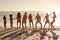 Multi-ethnic group of male and female dancing on the beach