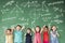 Multi-ethnic group of school children standing in classroom with math concept