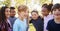 Multi-ethnic group of schoolchildren laughing, outdoors