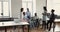 Multi ethnic staff listen African businesslady, team leader during meeting