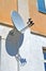 Multi-feed satellite antenna with multiple feeds converters on the building wall, telecommunication diversity,