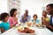 Multi Generation African American Family Praying At Home