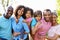 Multi Generation African American Family Standing In Garden