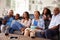 Multi generation black family watching movie on TV together