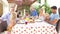 Multi Generation Family Enjoying Outdoor Meal Together