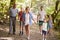 Multi Generation Family Enjoying Walk Along Woodland Path Together