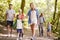 Multi Generation Family Enjoying Walk Along Woodland Path Together