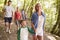 Multi Generation Family Enjoying Walk Along Woodland Path Together