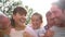 Multi Generation Family Giving Children Piggybacks Outdoors