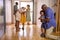 Multi-Generation Family With Grandparents Greeting Grandchildren in Hallway At Home