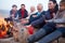 Multi Generation Family Having Barbeque On Winter Beach