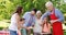 Multi-generation family having their lunch in the park