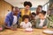 Multi-Generation Family With Military Father Celebrating Birthday With Cake Ay Home